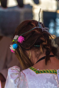 Rear view of girl wearing flowers