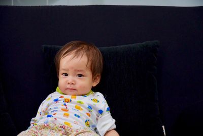 Portrait of baby reclining on bed