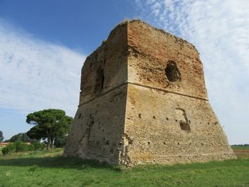 Low angle view of old ruin historical tower building against sky