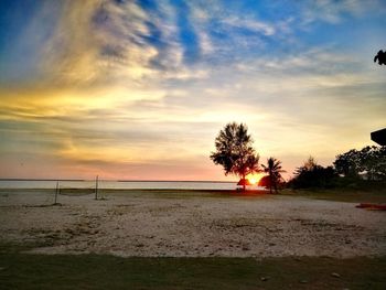 Scenic view of beach against sky during sunset