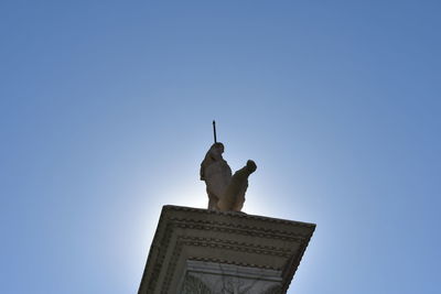 Low angle view of statue against clear blue sky
