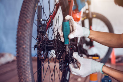 Close-up of man with bicycle on metal