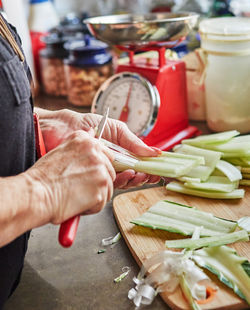 Midsection of man preparing food in kitchen