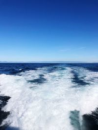 Scenic view of sea against clear blue sky