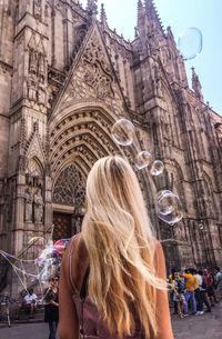 Rear view of women against church