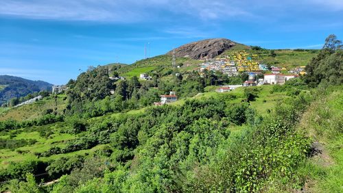 Panoramic view of buildings and mountains against sky