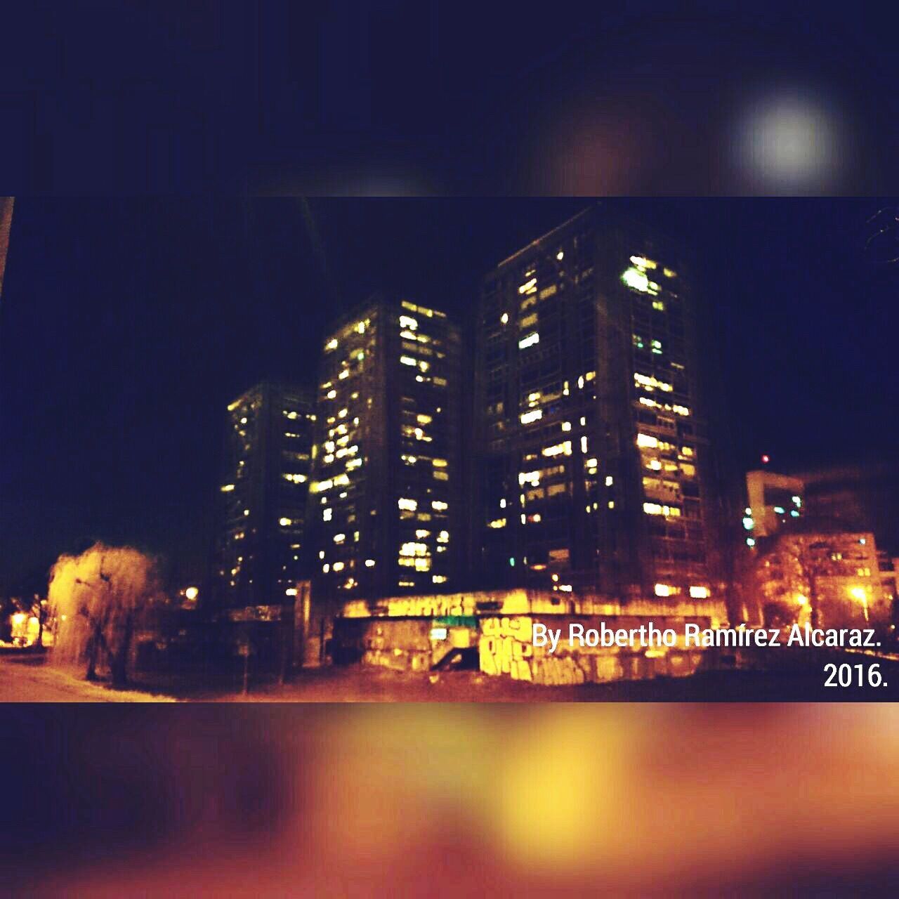 MODERN BUILDINGS IN CITY AT NIGHT