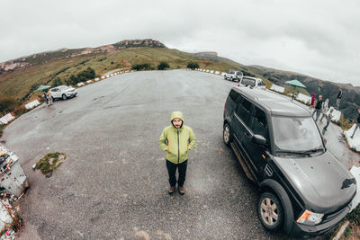 Full length of young man standing on road