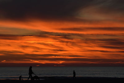 Scenic view of sea against orange sky