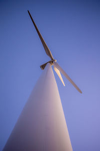 Wind turbine with purple sky during dusk