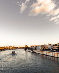 View of bridge over river against cloudy sky