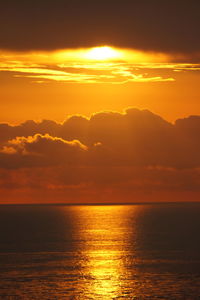 Scenic view of sea against romantic sky at sunset