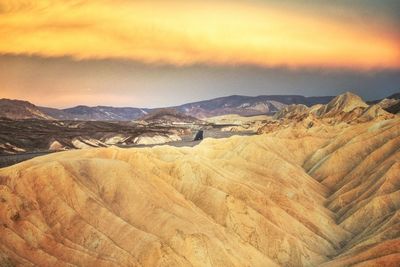 Scenic view of mountains against cloudy sky