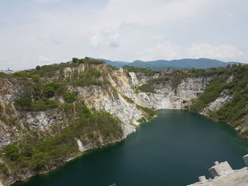 High angle view of river amidst mountains against sky