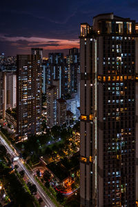 High angle view of illuminated buildings in city at night