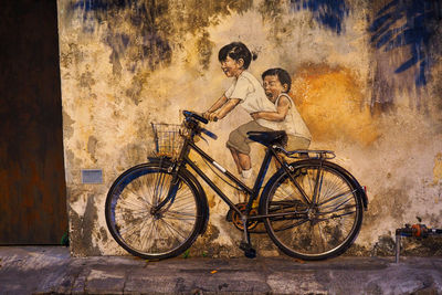 Bicycle parked against wall