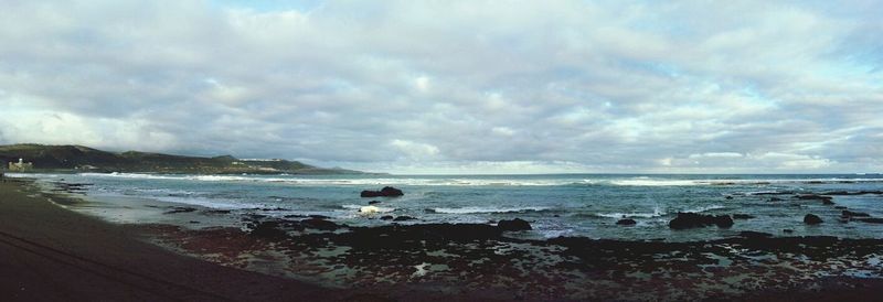 Scenic view of sea against cloudy sky