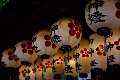 Low angle view of illuminated lanterns hanging at night