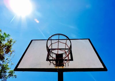 Low angle view of basketball hoop against blue sky