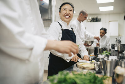Portrait of smiling friends having food at home