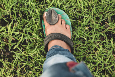 Low section of person wearing shoes on field