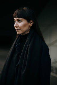 Brunette woman wearing a black coat