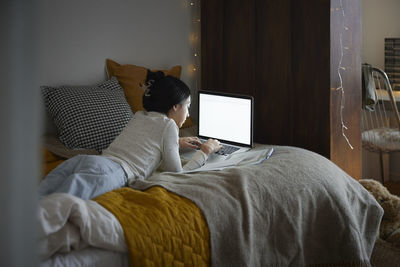 Young woman using laptop at home