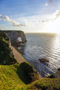 Idyllic shot of rock formation at sea against sky in etretat