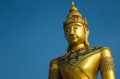 Low angle view of statue against blue sky