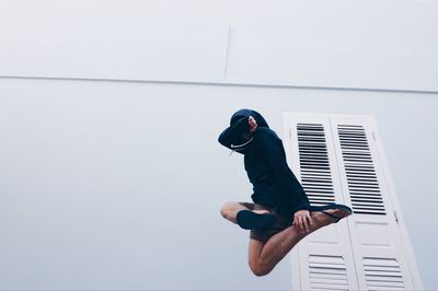 Full length of young man against wall