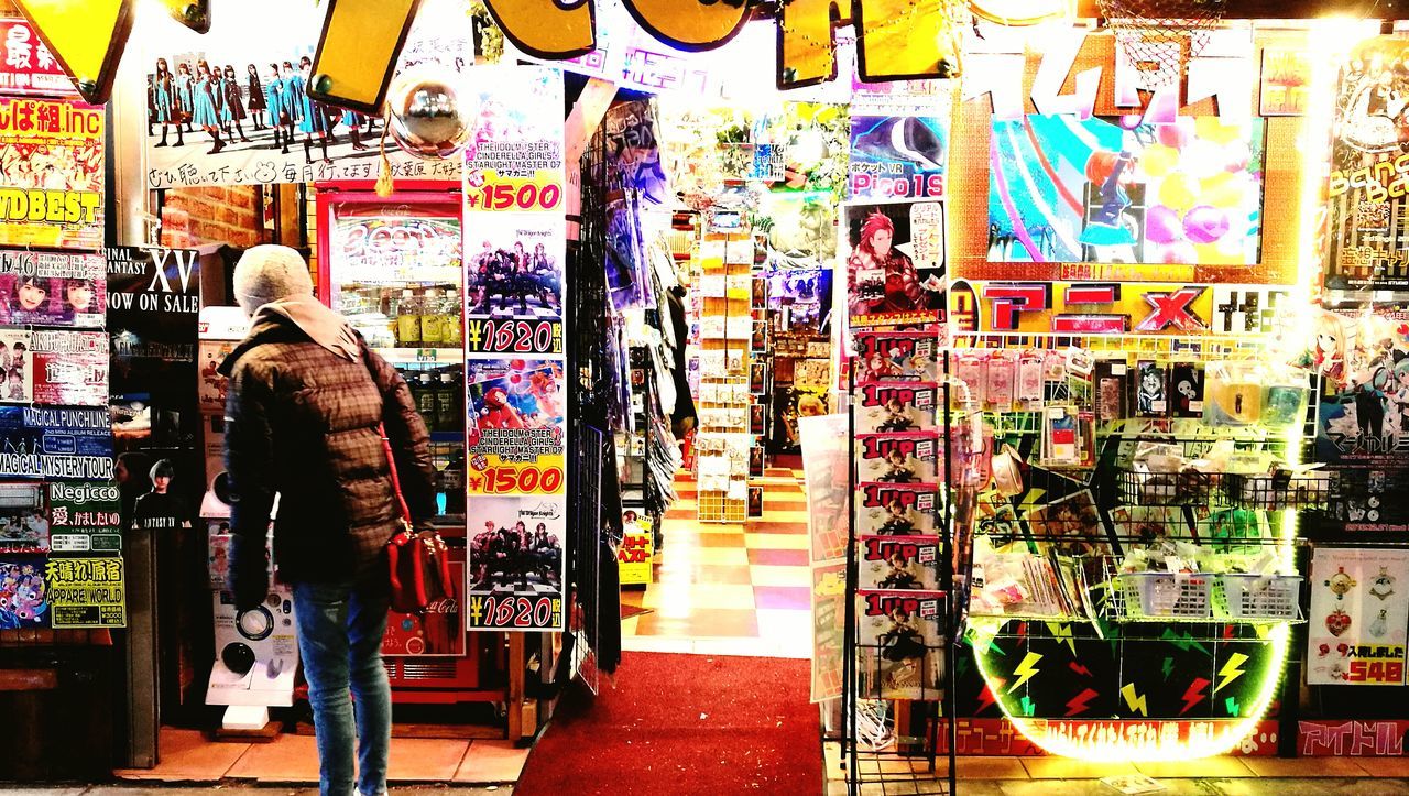 MAN STANDING IN COLORFUL STORE