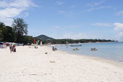 Scenic view of beach against sky on sunny day