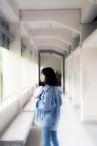 Woman standing in corridor of building