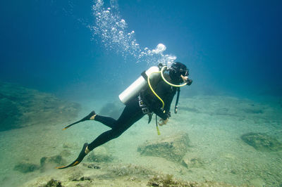 Woman scuba diving in sea