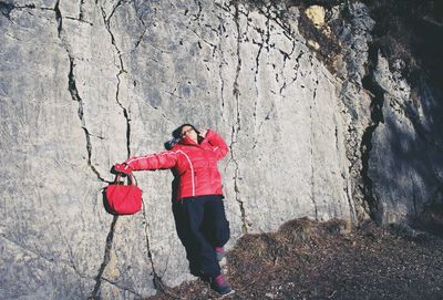 Rear view of woman standing on rock