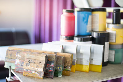 Close-up of multi colored bottles on table