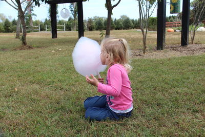 Rear view of girl on field