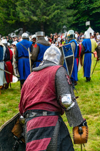 Rear view of people on field