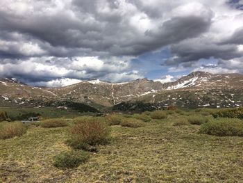 Scenic view of mountains against cloudy sky