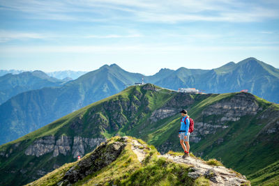 Man looking at mountains against sky