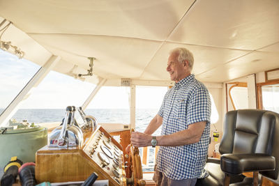 Confident senior man steering a boat