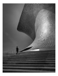 Low angle view of man walking on staircase