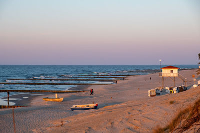 Scenic view of beach against sky during sunset