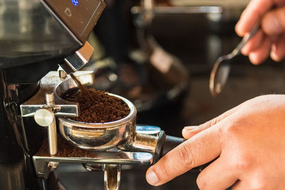 Cropped image of person holding coffee cup