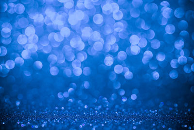 A white bokeh over the blue background.