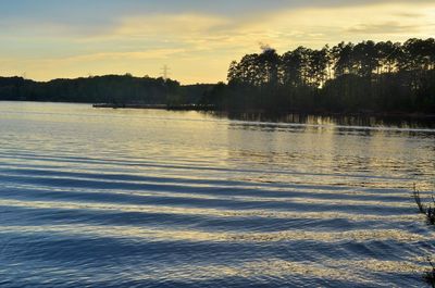 Scenic view of lake against sky at sunset