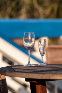 Empty wine glass and champagne flute on a table at the beach in florida.