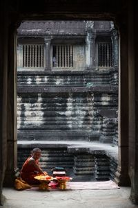 Monk sitting at old ruin temple 
