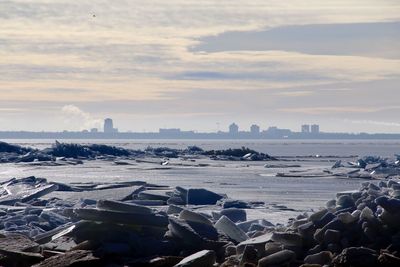 Ice floating on baltic sea against cloudy sky