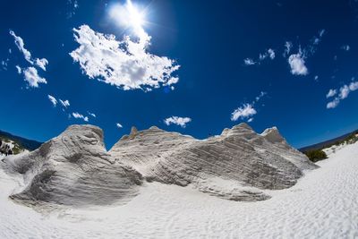 Scenic view of beach against blue sky